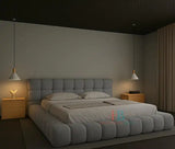 Modern grey teddy fabric bubble bed frame with padded headboard and gas lift storage, styled in a minimal bedroom with wooden nightstands and pendant lighting